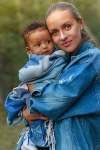 mom and adopted son looking at the camera and bonding after family therapy meeting with a family Houston therapist