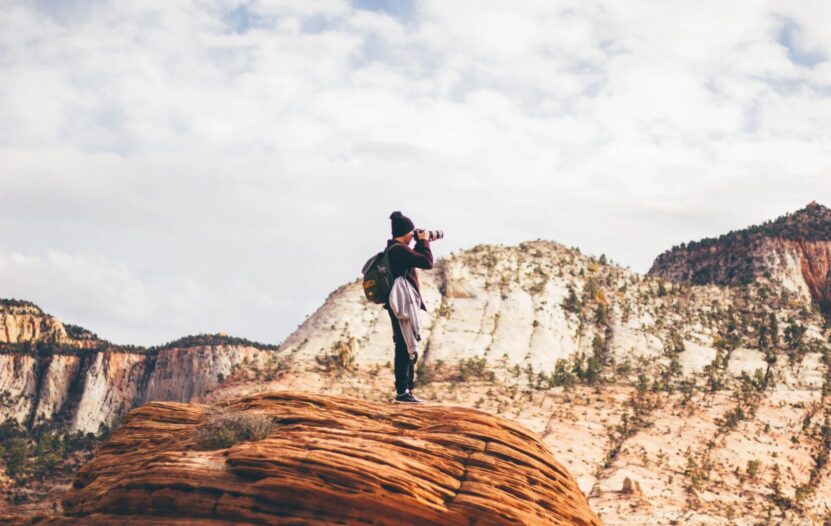 Photographer on mountain taking photo.