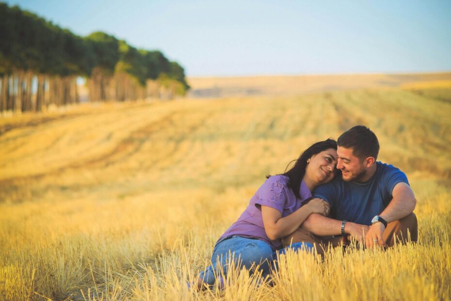 Couple embracing in a golden field.