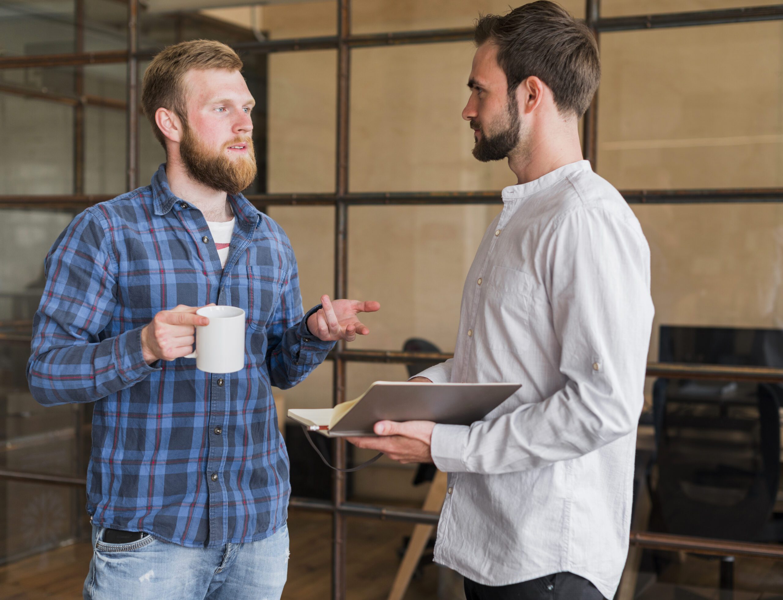 Two men having a casual office conversation.