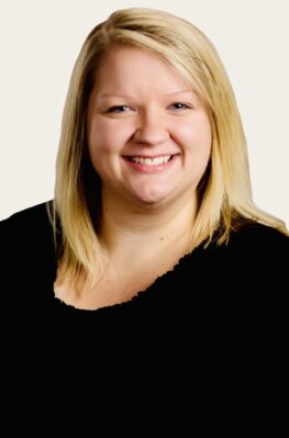 Smiling woman with blonde hair.