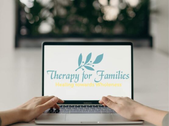 Laptop showing Therapy for Families logo.
