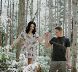 A happy couple takes a walk in the forest after growing closer through couples counseling near Houston, and Midland, TX.