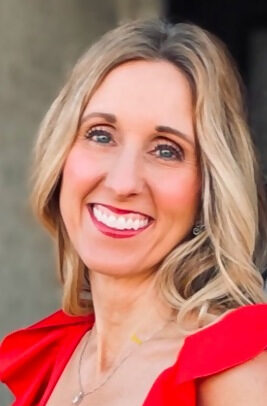 Smiling woman wearing a red dress.