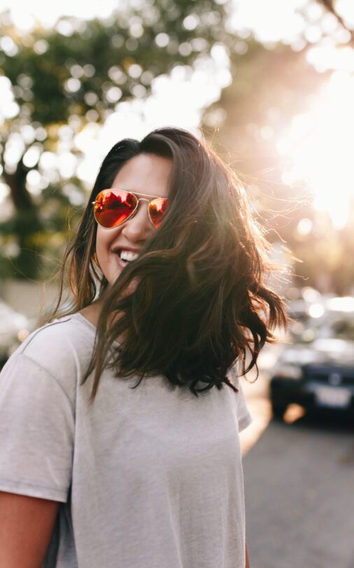 A woman stands in the sunlight feeling joy after starting individual counseling with a therapist at Therapy for Families in Houston, the Woodlands, Kemah, Bellville and Midland.