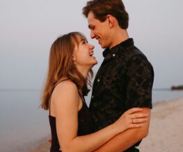 Happy couple embracing on beach.